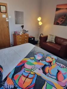 a bedroom with a bed with a painting on it at Pride Lodge in Blackpool