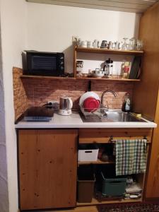a kitchen with a sink and a counter top at Appartement Silvia in Ammerbuch +3 photos