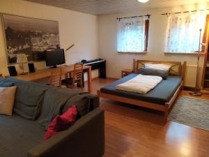 a living room with a bed and a couch at Appartement Silvia in Ammerbuch