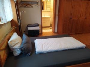 a bed with two pillows on top of it at Appartement Silvia in Ammerbuch