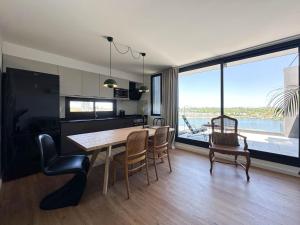a kitchen and dining room with a table and chairs at Lake Life Exclusivo apartamento en Parque Miramar in Montevideo