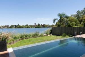 a swimming pool with a view of a lake at Lake Life Exclusivo apartamento en Parque Miramar in Montevideo
