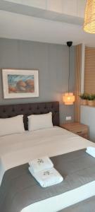 a bedroom with a bed with two towels on it at Seaside Studios in Paralia Dionysiou