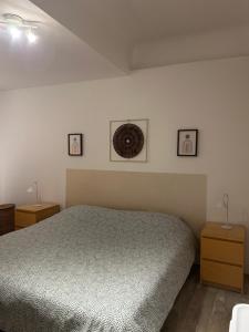 a bedroom with a bed and three pictures on the wall at fontaine in Aups