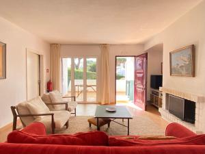 a living room with a couch and a fireplace at Casa Manacá Vilamoura in Quarteira +7 photos