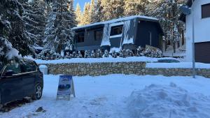 a car parked in front of a house in the snow at Vila Beganovic in Šišava +8 photos