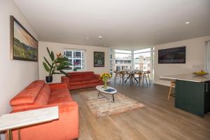 a living room with a red couch and a table at Parnell Corner Apartments in Dublin