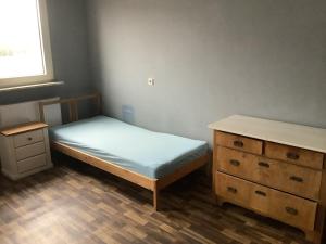 a small bedroom with a bed and a dresser at Adler in Kraichtal