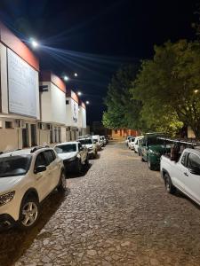 a row of cars parked in a parking lot at night at Hotel Ibajé in Bagé +12 photos
