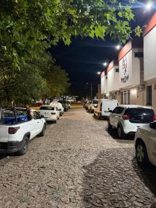 a row of cars parked in a parking lot at night at Hotel Ibajé in Bagé