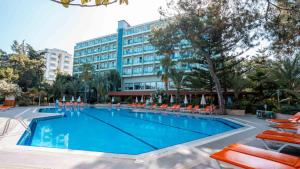 a large swimming pool in front of a hotel at İncekum West Hotel -Ultra All Inclusive in Alanya