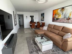 a living room with a couch and a table at Penthouse Mojacar beach newly build in Mojácar