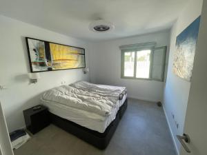 a bedroom with a bed in a room with a window at Penthouse Mojacar beach newly build in Mojácar