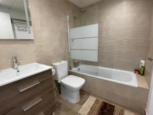 a bathroom with a tub and a toilet and a sink at Penthouse Mojacar beach newly build in Mojácar +20 photos
