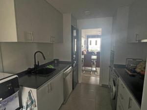 a kitchen with a sink and a counter top at Penthouse Mojacar beach newly build in Mojácar
