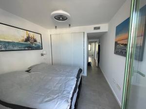 a small bedroom with a bed and a hallway at Penthouse Mojacar beach newly build in Mojácar