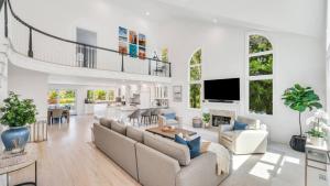 a living room with a couch and a table at Villa Saltwater Haven in East Hampton