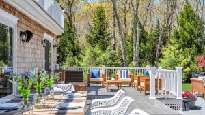 a patio with chairs and tables on a house at Villa Saltwater Haven in East Hampton