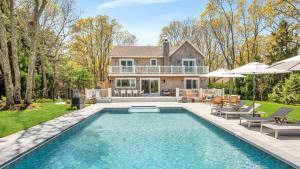 a home with a swimming pool and a house at Villa Saltwater Haven in East Hampton