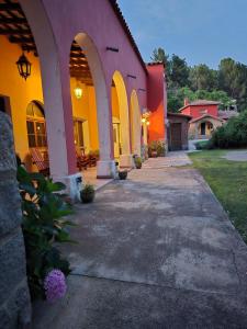 a building with arches and a walkway at Hotel Zapata in La Cumbre