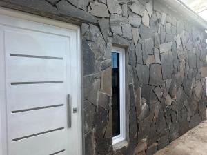 a stone wall next to a garage door at Departamento Helen in Termas de Río Hondo