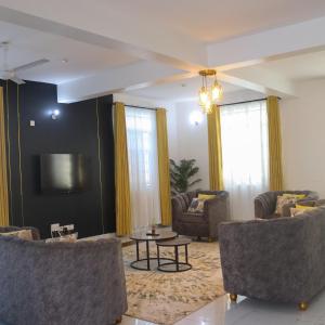 a living room with two couches and a table at Leah's Luxury Villa in Mombasa