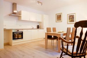 a kitchen with a wooden table and a dining room at haus Plager in Landau an der Isar