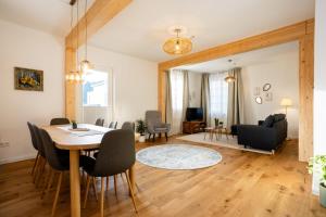 a dining room and living room with a table and chairs at Mariene Home Apartments - Am Hammer in Rösrath