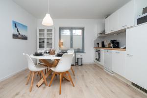 a kitchen with a table and chairs in a room at Liehrstraße 9 by Baltic Home in Heringsdorf