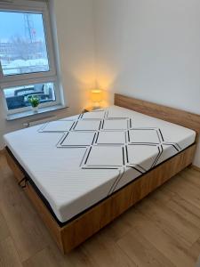 a large bed in a room with a window at Apartament Mike - free parking self check-in in Giżycko