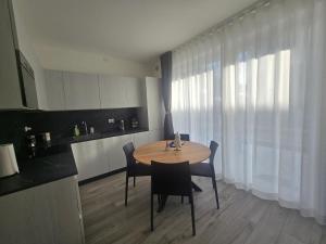 a kitchen with a table and chairs in a room at Home23Jesolo! Beach, Parking and Bikes included in Lido di Jesolo