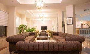 a large living room with couches and a flat screen tv at İncekum West Hotel -Ultra All Inclusive in Alanya