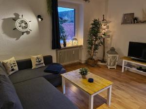 a living room with a couch and a coffee table at Waldblick Ferienwohnungen in Bonndorf im Schwarzwald