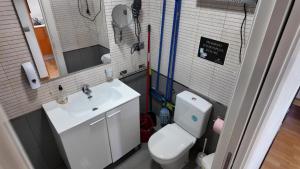 a small bathroom with a toilet and a sink at Apartalux Pax Palace in Las Negras