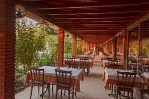 a row of tables and chairs on a patio at İncekum West Hotel -Ultra All Inclusive in Alanya