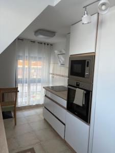 a kitchen with a stove and a microwave at Schäferstr 43 in Peine