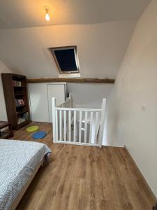 a bedroom with a bed and a crib and a tv at Duplex proche aéroport CDG et Paris in Sarcelles