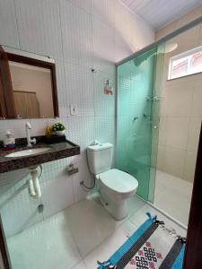 a bathroom with a toilet and a glass shower at Casa dos Ventos Barreirinhas in Barreirinhas +30 photos