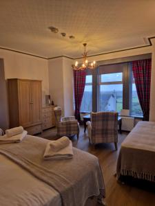a bedroom with two beds and a room with a window at St Olaf Golf Hotel in Cruden Bay