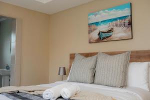 a bedroom with a bed with a painting on the wall at Infinity Home BnB in Leribe