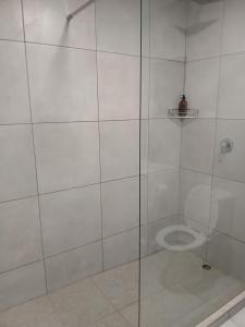a bathroom with a glass shower with a toilet at Kinn Accommodation in Bloemfontein