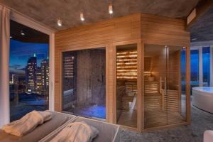 a large bathroom with a tub and a view of the city at J44 Lifestyle Hotel in Lido di Jesolo