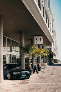 a black car parked in front of a building at J44 Lifestyle Hotel in Lido di Jesolo