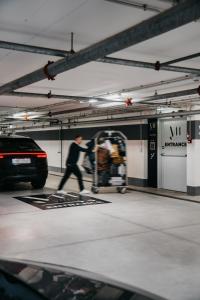 a man is walking in a parking garage at J44 Lifestyle Hotel in Lido di Jesolo +155 photos