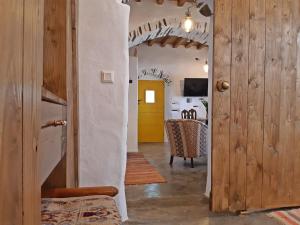 a hallway of a house with a yellow door at Kostoulis Traditional House in Lefkes