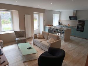 a living room with a couch and a table at Gite les trois Petiots in Pirou