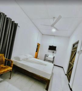 a bedroom with a bed and a ceiling fan at Meegas Sewana Resort in Minneriya