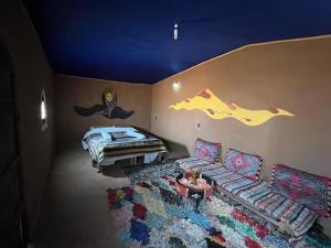 a living room with a couch and a bed at Sahara Authentic Berber Camp in Mhamid +20 photos