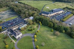 an aerial view of a building with a parking lot at The Dark Hedges Hotel in Stranocum