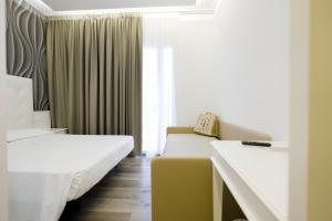 a hotel room with two beds and a window at Hotel President in Lido di Jesolo +69 photos